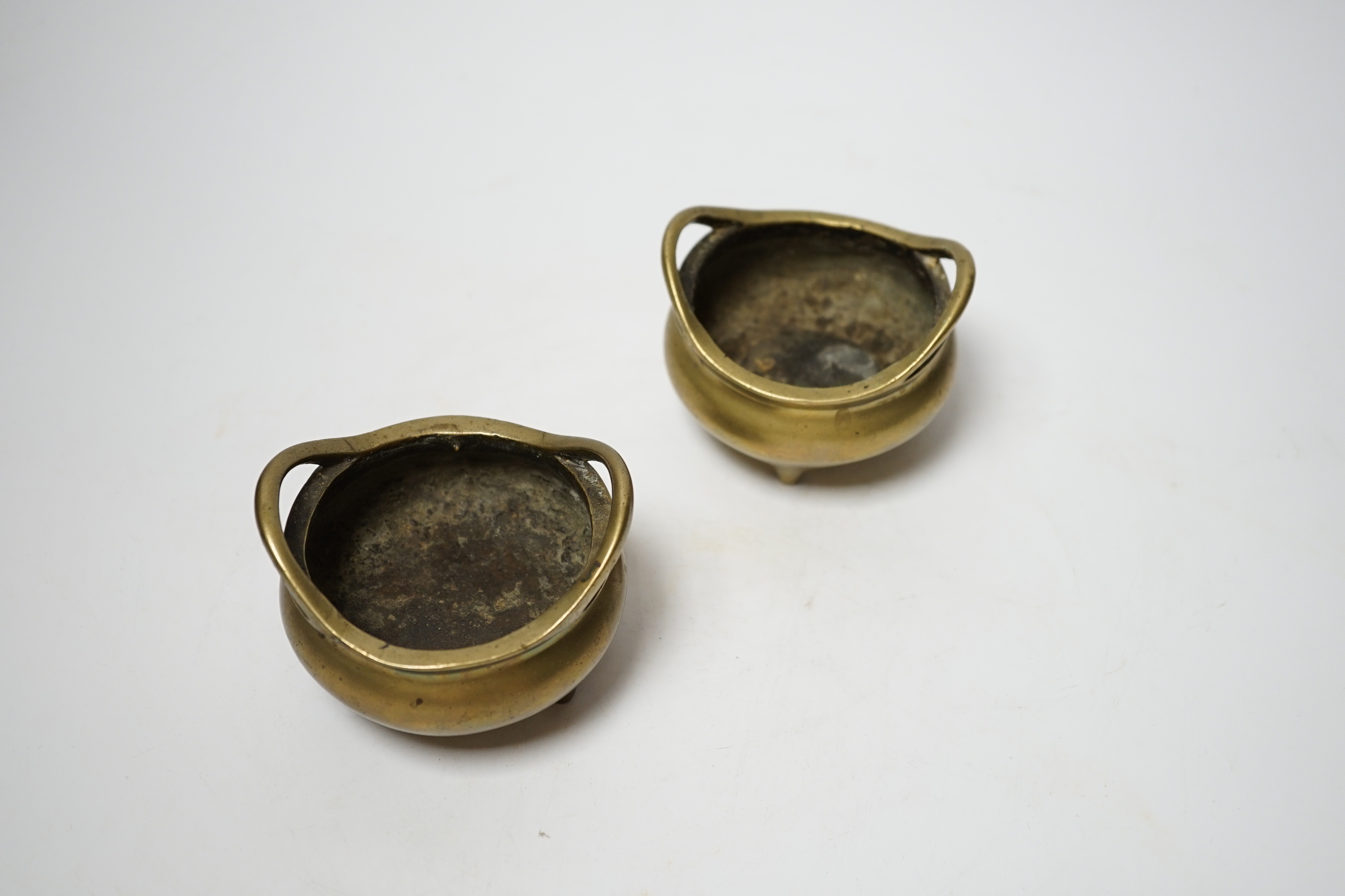 A pair of late 19th/early 20th century Chinese bronze censers, 8.5cm handle to handle